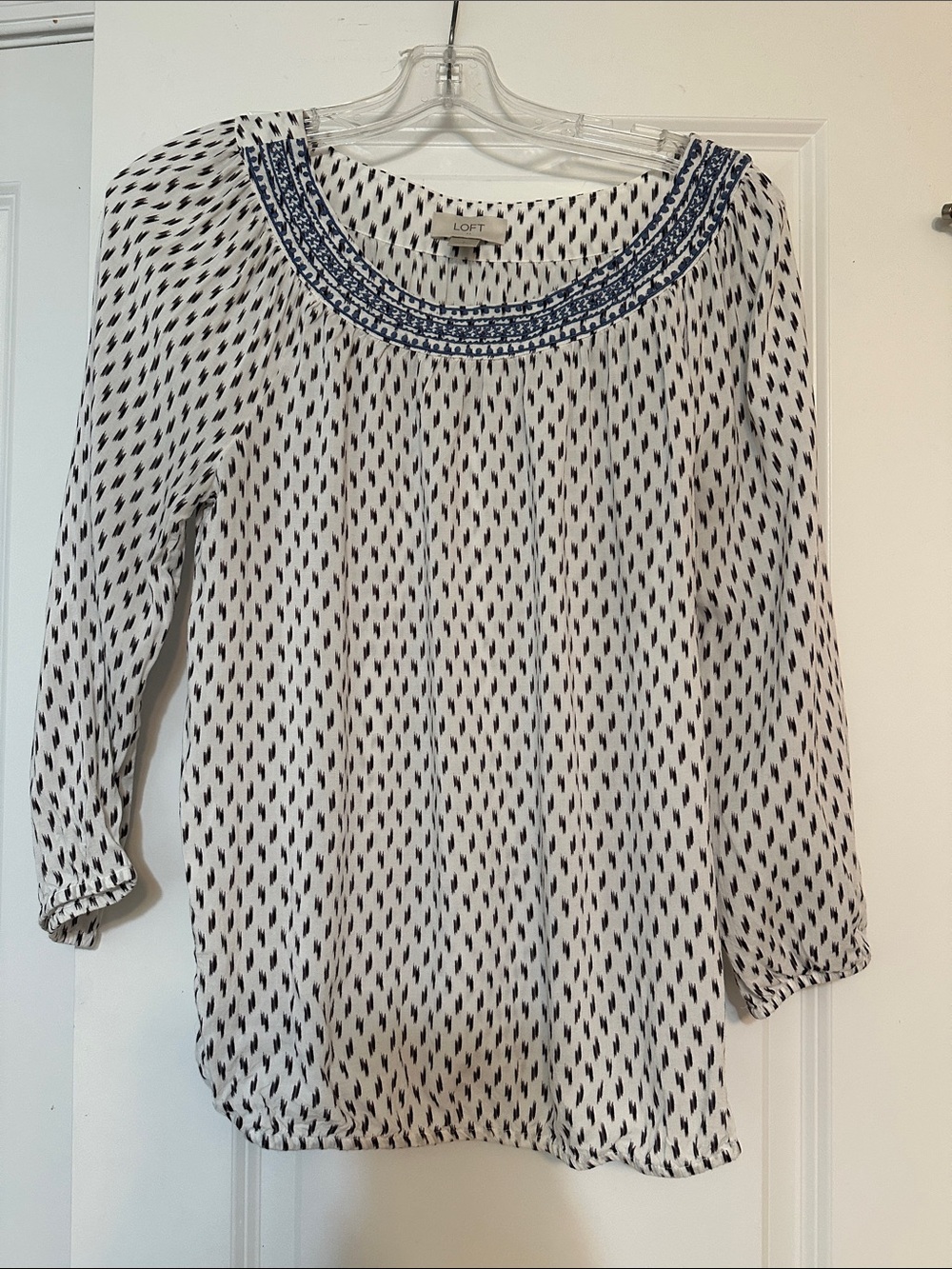 Sz S LOFT blouse white with black ikat print blue embroidered detailing neckline